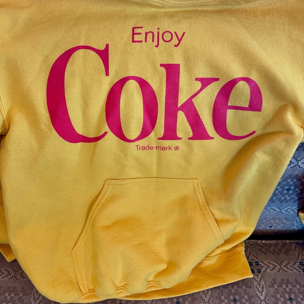 Enjoy Coke hoodie with front pocket.  Coca-cola and Coke logos down one arm.